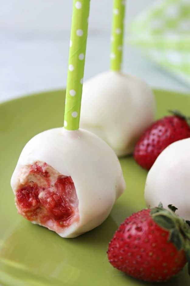 Strawberry shortcake cake pops made from crumbled pound cake and vanilla frosting, dipped in white candy coating for spring
