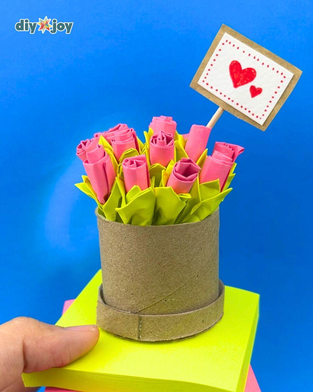 Finished pink and green paper rose bouquet in its cardboard vase, an easy Post-it note flower tutorial