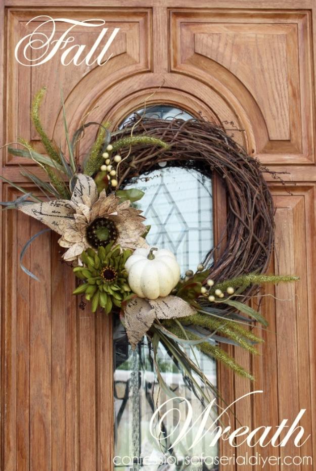 Grapevine wreath dressed with a white pumpkin, a sunflower and wheat on a wood door, a classic fall look