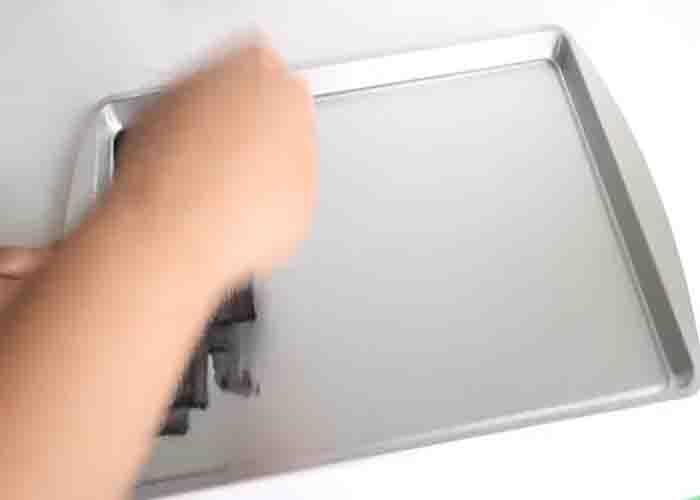 Coloring the pizza sheet pan to make the magnetic spice display