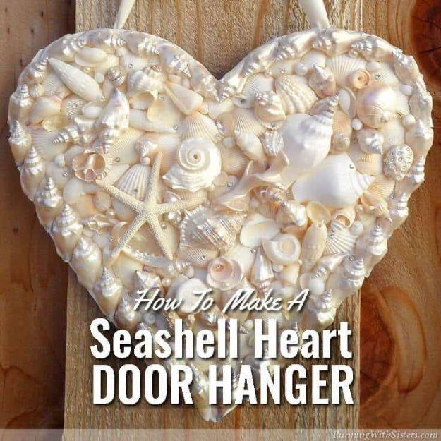 Seashell heart door hanger, a wooden heart covered in cream shells, starfish and pearls on a wood door