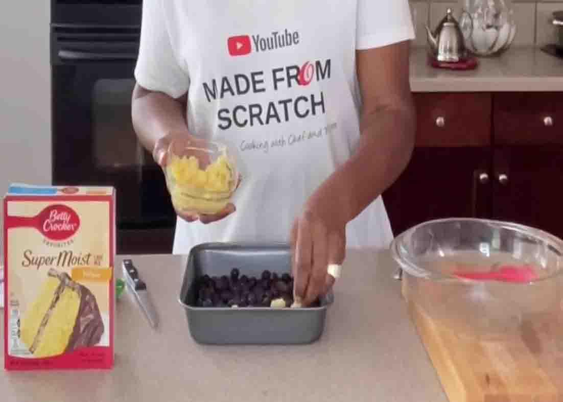 Adding the pineapple to the blueberry dump cake