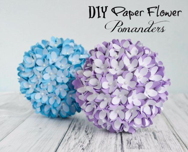 Paper flower pomander, one blue and one lavender paper flower covered kissing ball on weathered white wood