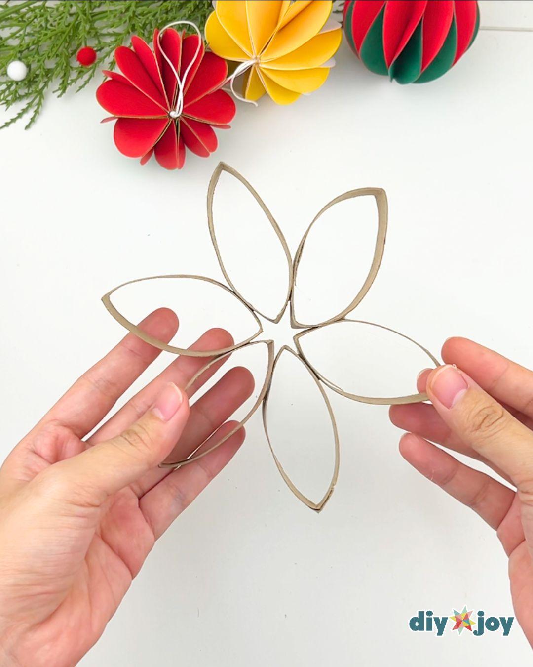 Homemade Christmas Ornaments Snowflake Toilet Paper Tubes — making the flower shape
