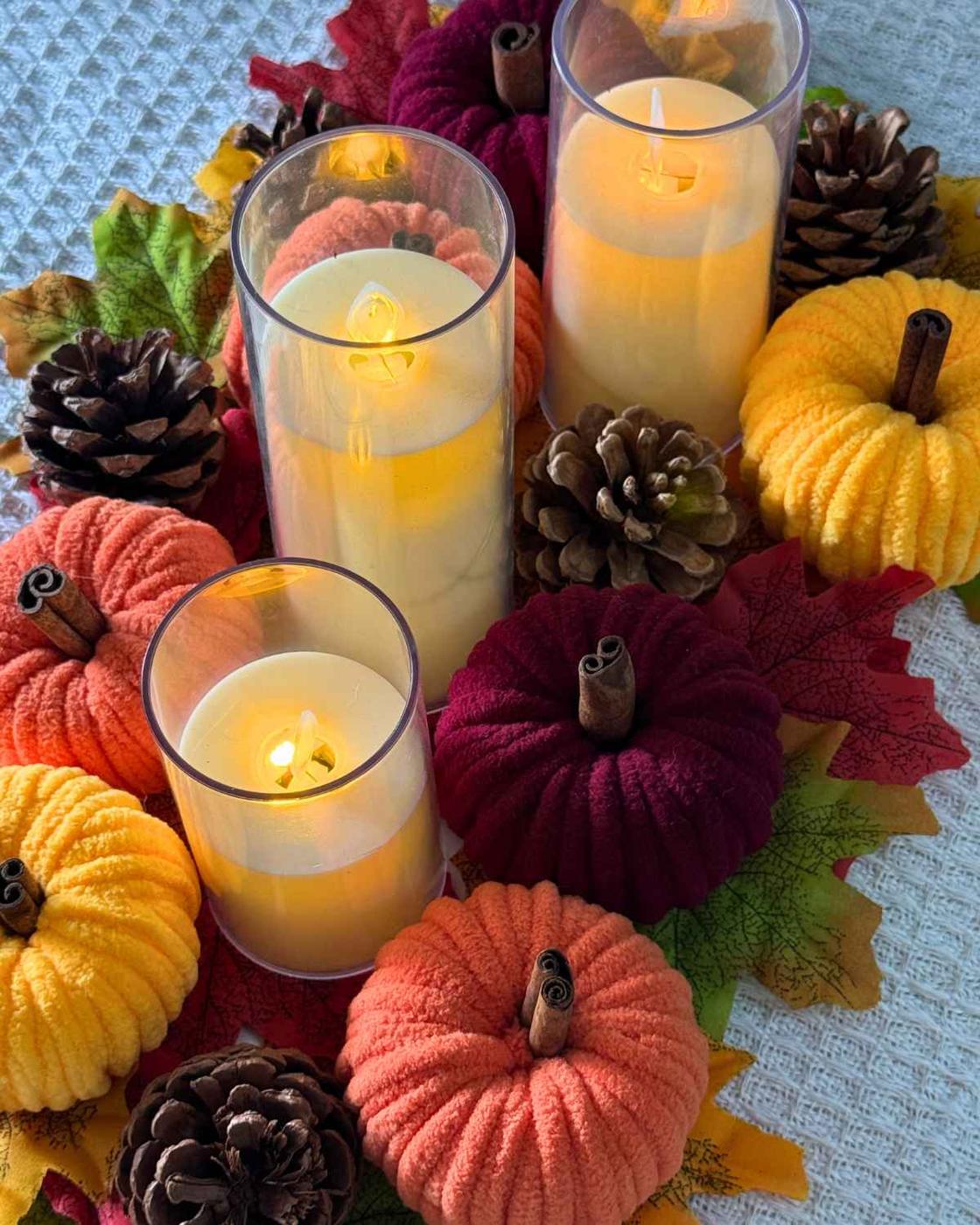 Pumpkin Crafts - yarn pumpkins in fall colors displayed together, one of many easy toilet paper roll crafts.
