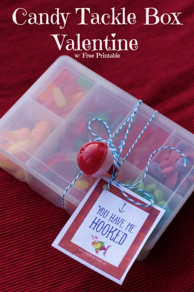 Plastic tackle box with compartments filled with sorted candy as a funny Valentine's gift for him on a craft table