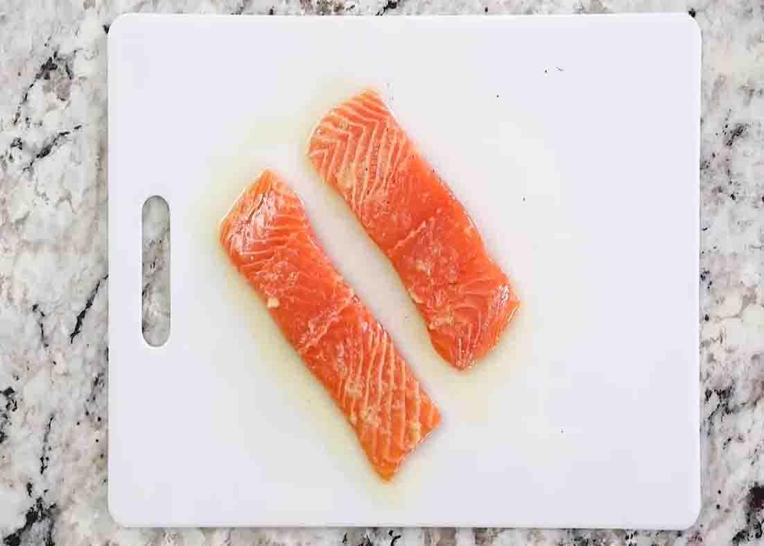 Drizzling some olive oil over the salmon fillets