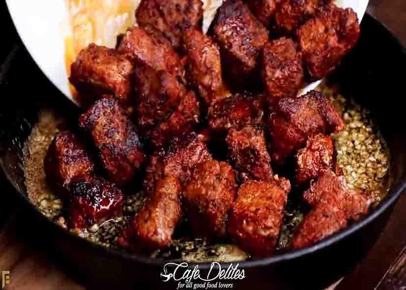 Mixing the steak bites with garlic and butter