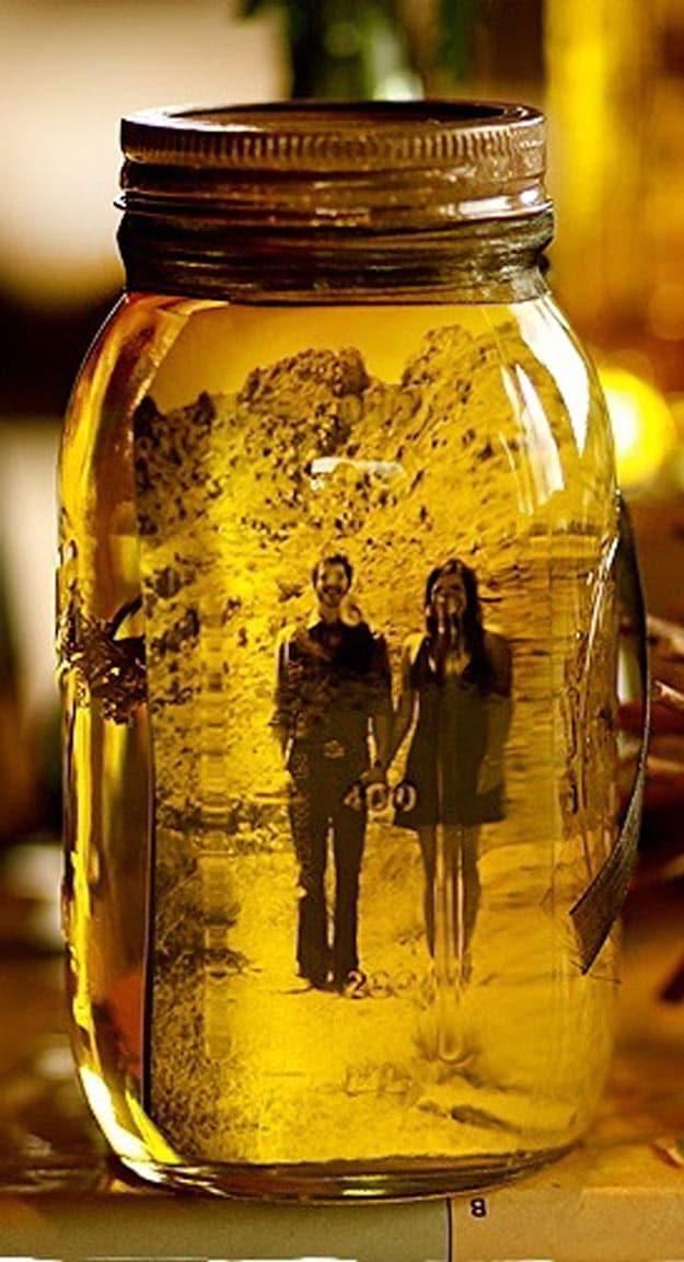 Vintage photo curled inside a water filled mason jar sitting on a shelf as a keepsake Valentine gift