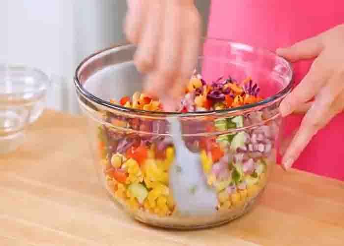 Mixing all the rainbow salad ingredients