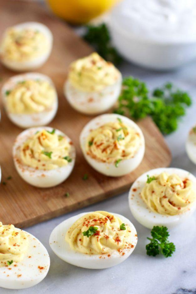 Greek yogurt deviled eggs dusted with paprika on a platter, a lighter gluten free party appetizer recipe