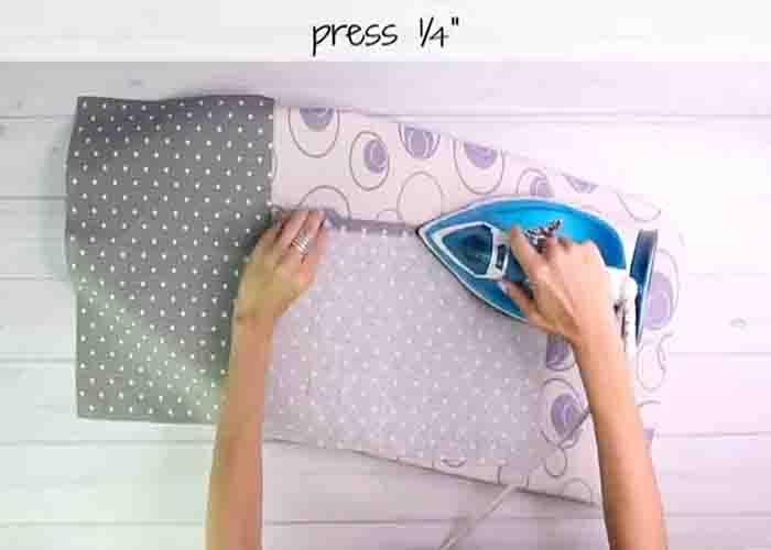 Pressing the seam to make the pom pom cushion cover