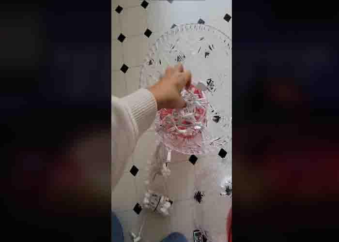 Adding the Christmas lights to the punch bowls to make the giant Christmas candies