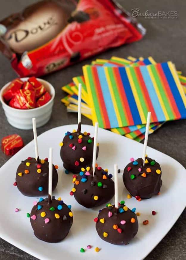 Fudgy brownie cake pops rolled from boxed brownie mix, dipped in dark chocolate and sprinkled with sprinkles on a party tray