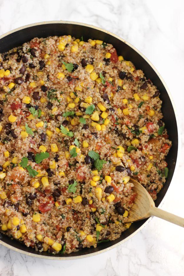 One pan Mexican quinoa with black beans, corn and tomatoes cooked together in a single skillet on the stove