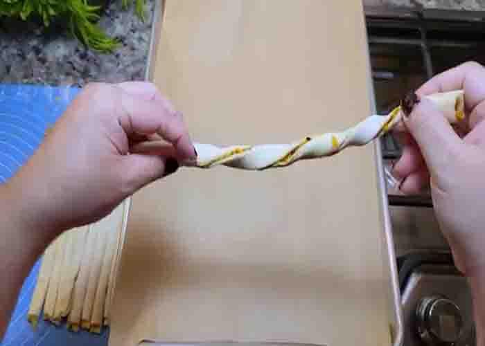 Twisting the puff pastry cheese straws