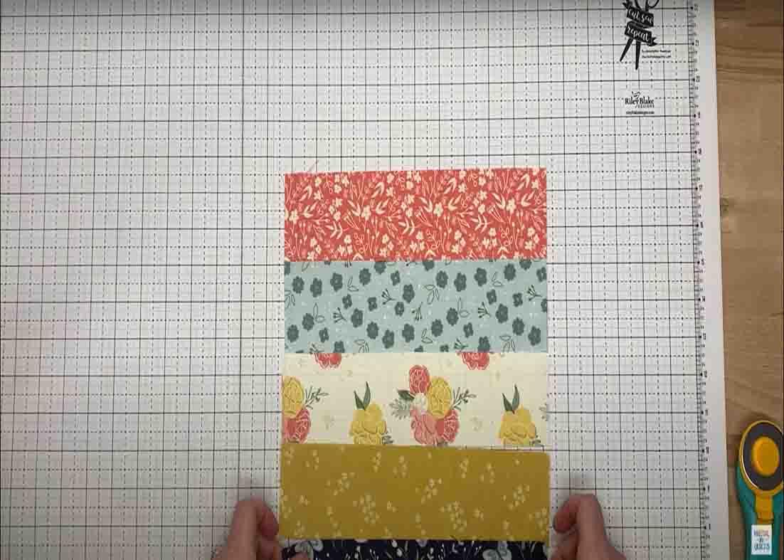 Laying out the strips to make the quarter stack quilt block