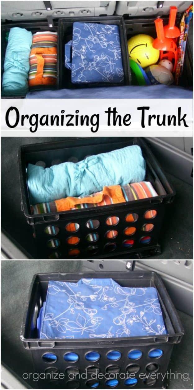 Organizing the trunk, three panels of black crates holding rolled blankets, a blue cloth, balls and outdoor toys