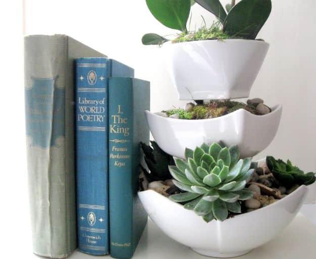 Succulent terrarium, three white ceramic bowls stacked and offset, planted with succulents and river pebbles