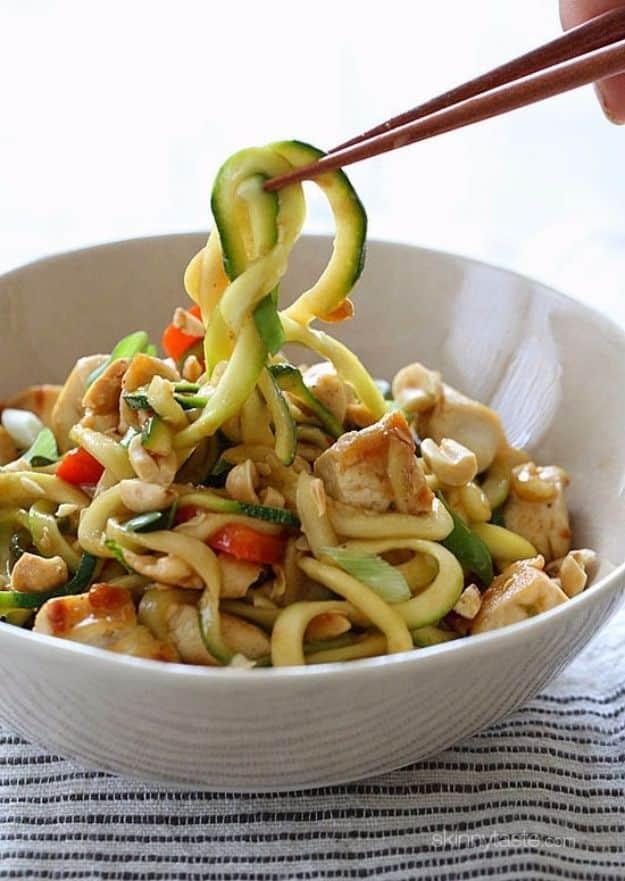 Kung pao chicken zoodles for two with spiralized zucchini, chicken and crushed peanuts in a glossy sauce
