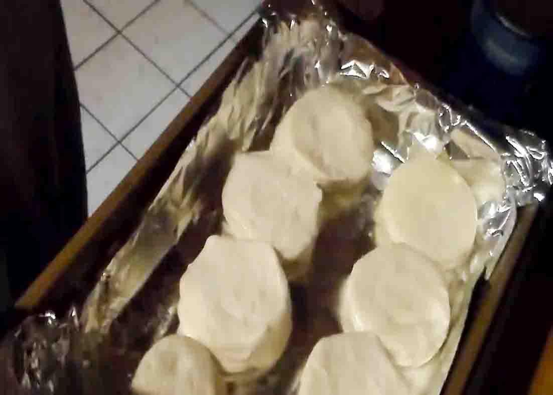 Layering up the canned biscuits on the bottom of the casserole