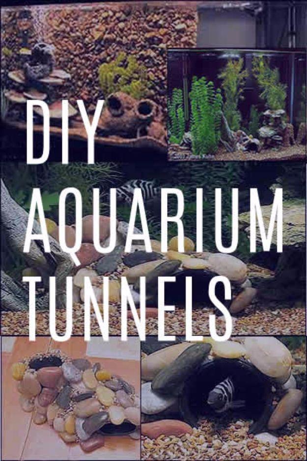 DIY aquarium tunnel covered in small rocks sitting on gravel inside a tank with two smaller detail panels