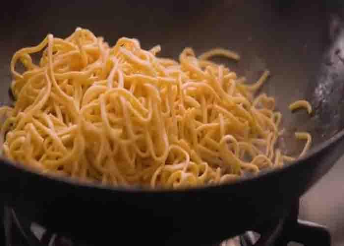 Tossing the noodles with the chili sauce