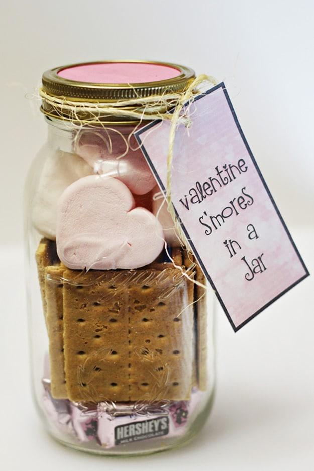 Mason jar layered with graham crackers chocolate and marshmallows as a complete s'mores kit gift idea for February 14