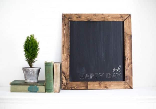 A framed board painted as a magnetic chalkboard hangs on a kitchen wall, a grocery list written across it