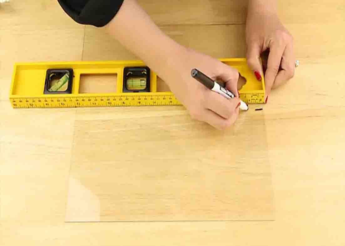 Marking the Dollar Tree frame glass for the DIY floating frame art