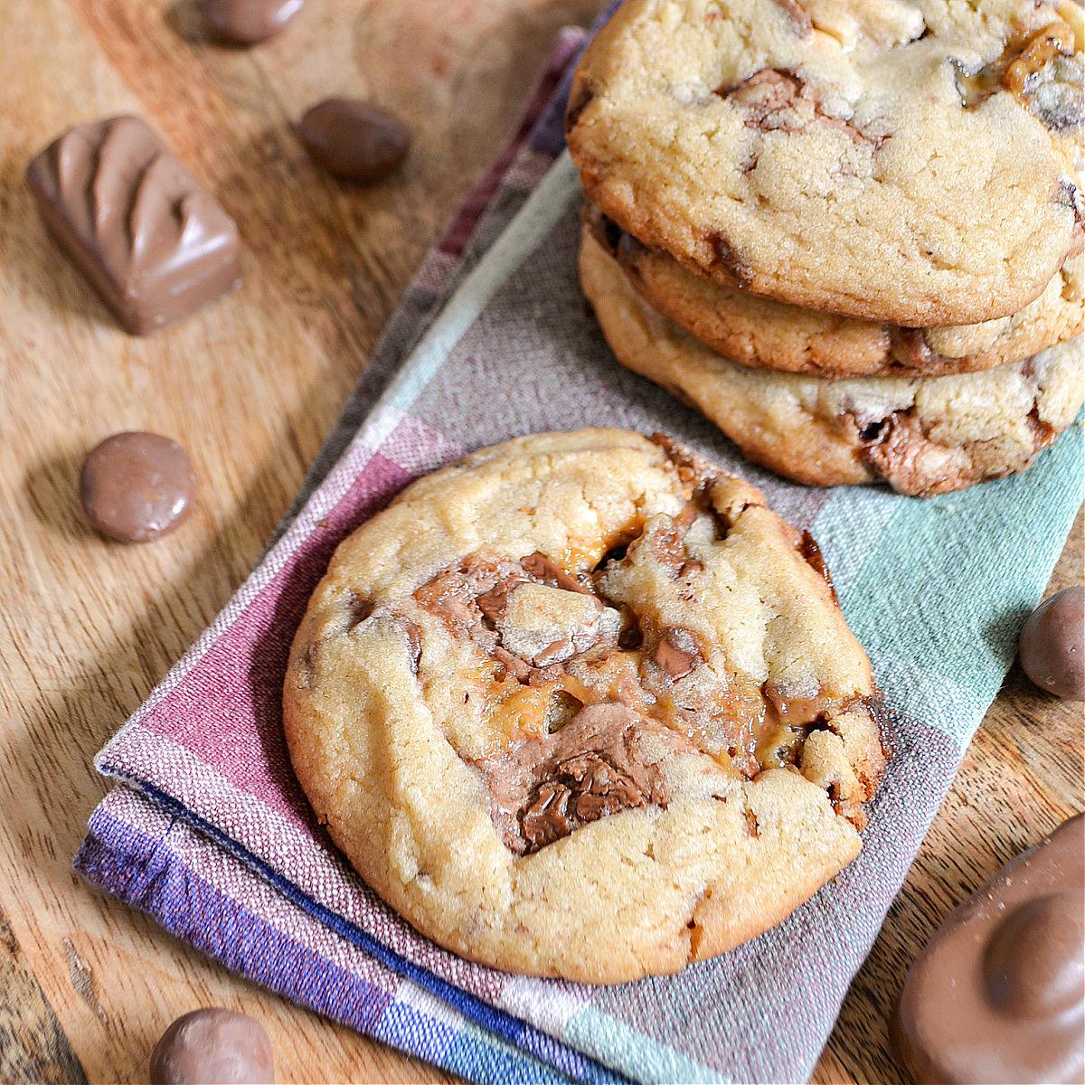 Thick golden cookies packed with visible pieces of chocolate caramel and leftover Halloween candy bars
