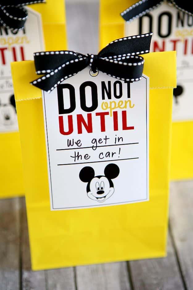 Disney trip fun bags, yellow paper treat bags with black ribbon and do not open until we get in the car tags