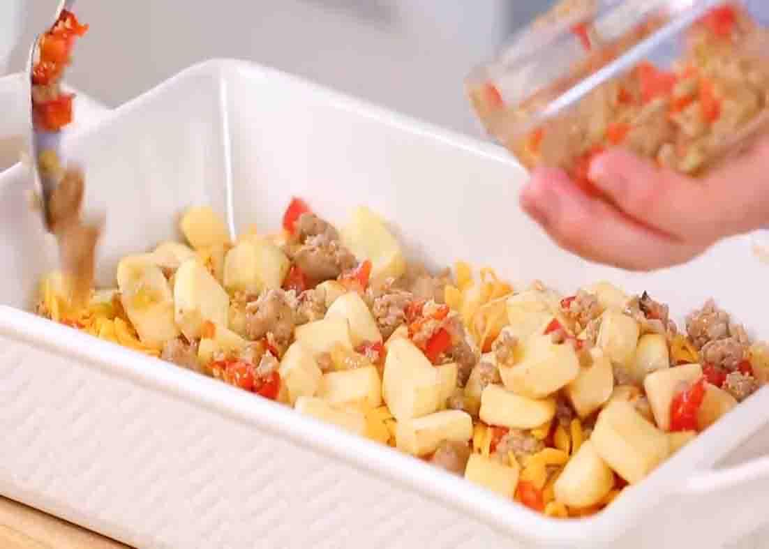 Assembling the layers of the breakfast casserole