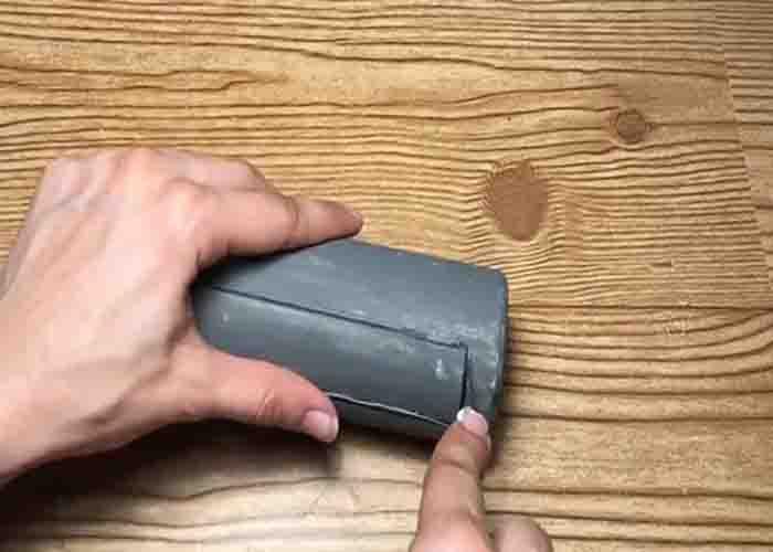 Cutting the ketchup bottle to make the rolling pin succulent planter