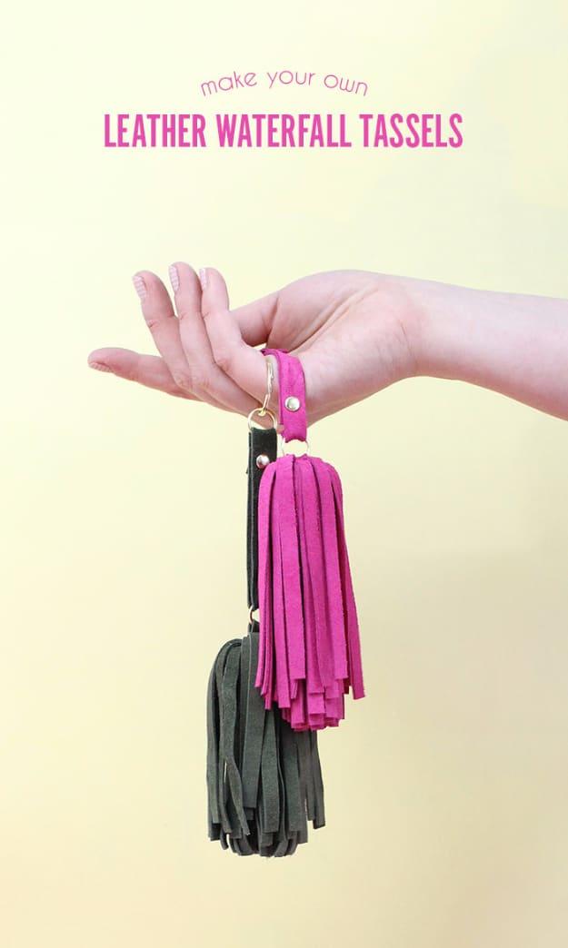 A row of leather tassel keychains in tan, blush and black, fringe hanging loose from silver rings, Etsy crafts