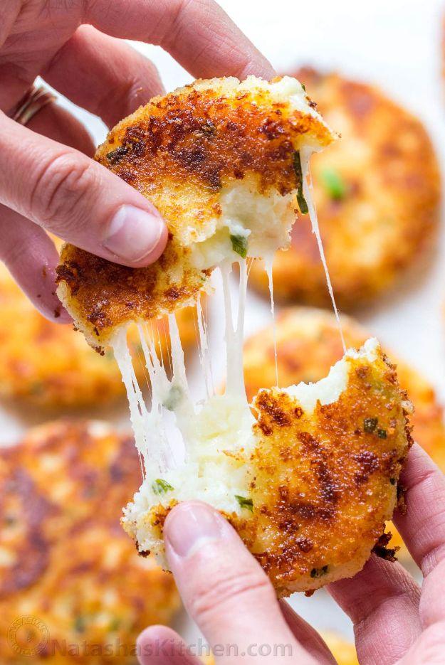 Two hands pulling a fried cheesy pancake in half, showing a long stretch of melted mozzarella inside it