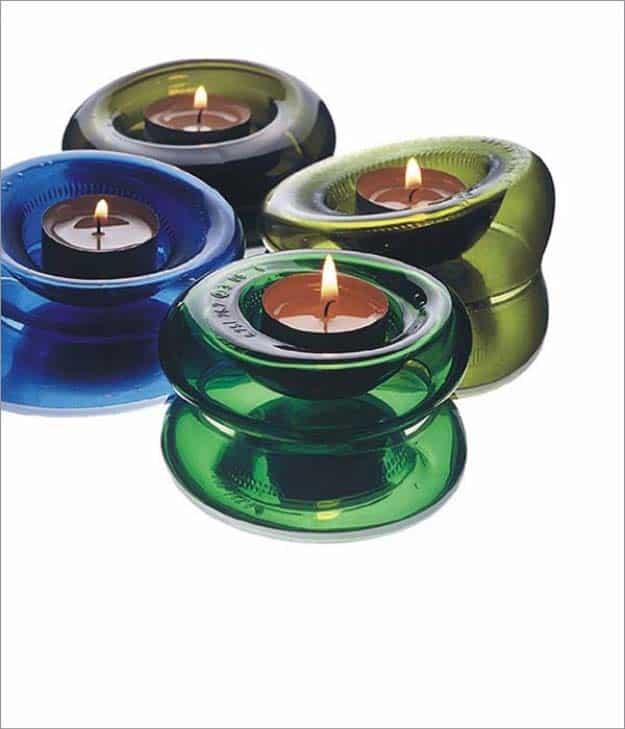 Bottle bottom candle holders in blue, green and olive glass slumped into rounded shapes holding tealights