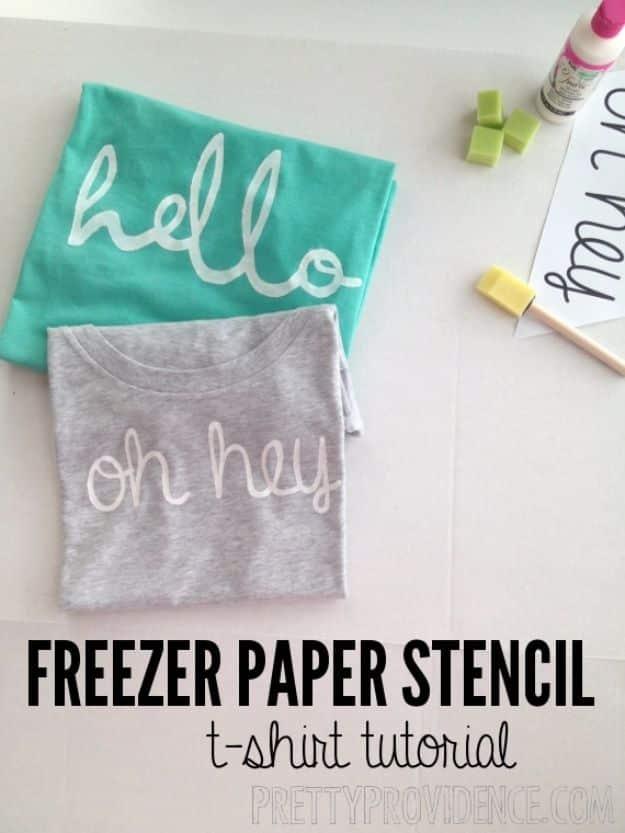 Freezer paper stencil t-shirt graphic with teal and gray shirts reading hello and oh hey in white paint