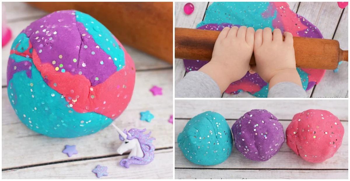 Marbled blue pink and purple unicorn playdough with glitter being rolled out with a wooden rolling pin