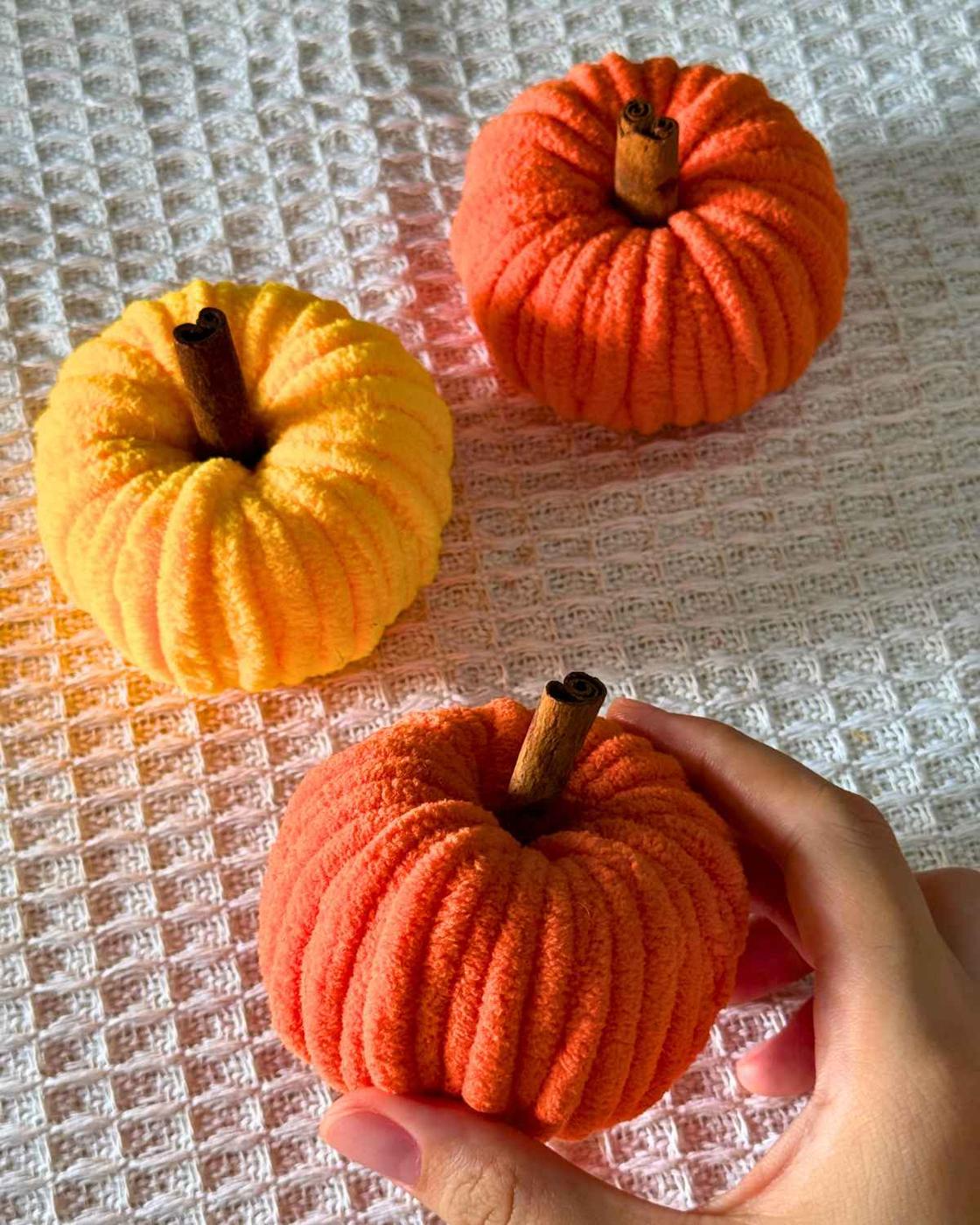 Cheap DIY Ideas - yarn pumpkins arranged for a cozy Thanksgiving centerpiece made from chenille yarn.