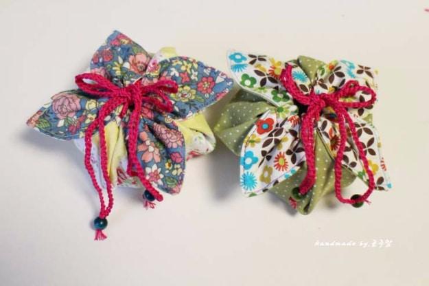 Small lined gift pouches with ribbon drawstrings in red and green prints, made from leftovers of a summer print