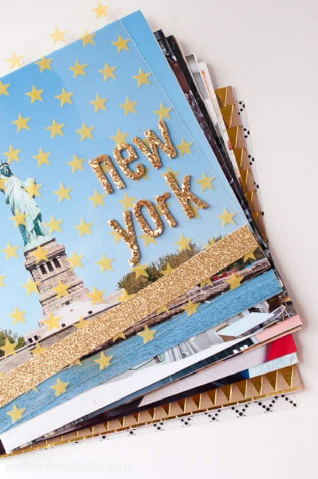 A stack of 8 by 8 inch travel album pages topped with a starry New York cover in gold glitter letters