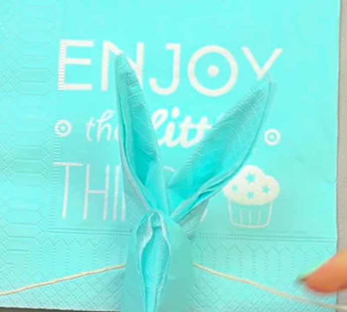 Fold a paper napkin into a an Easter bunny