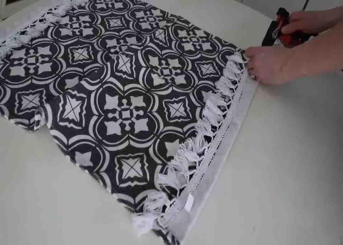 Gluing the mini rug from Dollar Tree to make oversized totes