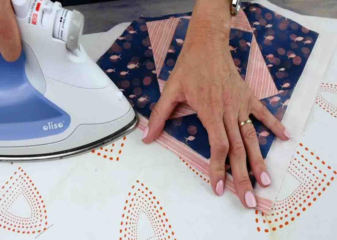 Gluing and pressing down the binding from backing fabric