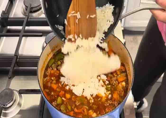 Adding the rice in the stuffed pepper soup recipe