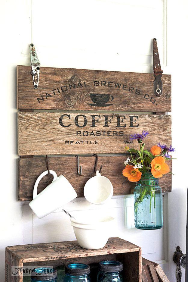 Coffee crate lid sign, three weathered planks stencilled with a coffee roasters logo, with white mugs on S hooks