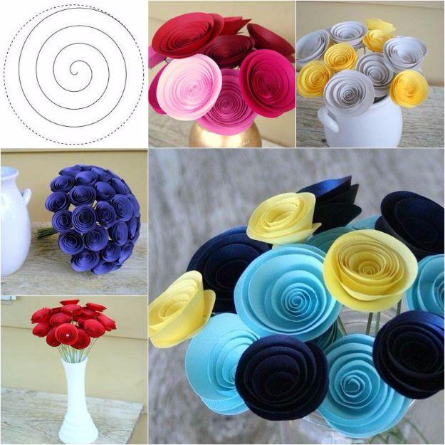Easy swirly paper flower, a spiral cut template beside rolled paper roses in pink, navy, yellow, cream and red