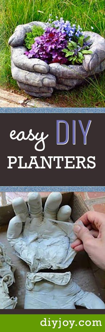 Concrete hand planters, cupped gray cement hands filled with soil and purple flowers sitting on green garden grass