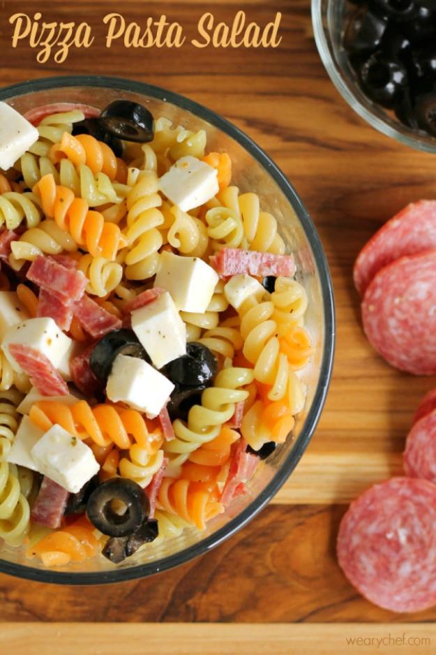 Typeset pin graphic of a glass bowl of tricolor rotini with black olive rings, cubed mozzarella and cubed salami